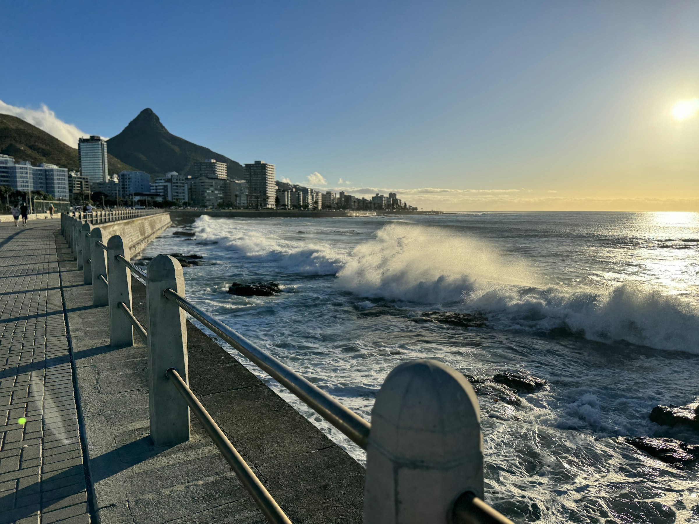 The promenade at Sea Point with Lion's Head behind. The last few kilometres come home beside the sea on Beach Road. Photograph: Niyo Niyonzima, Unsplash.