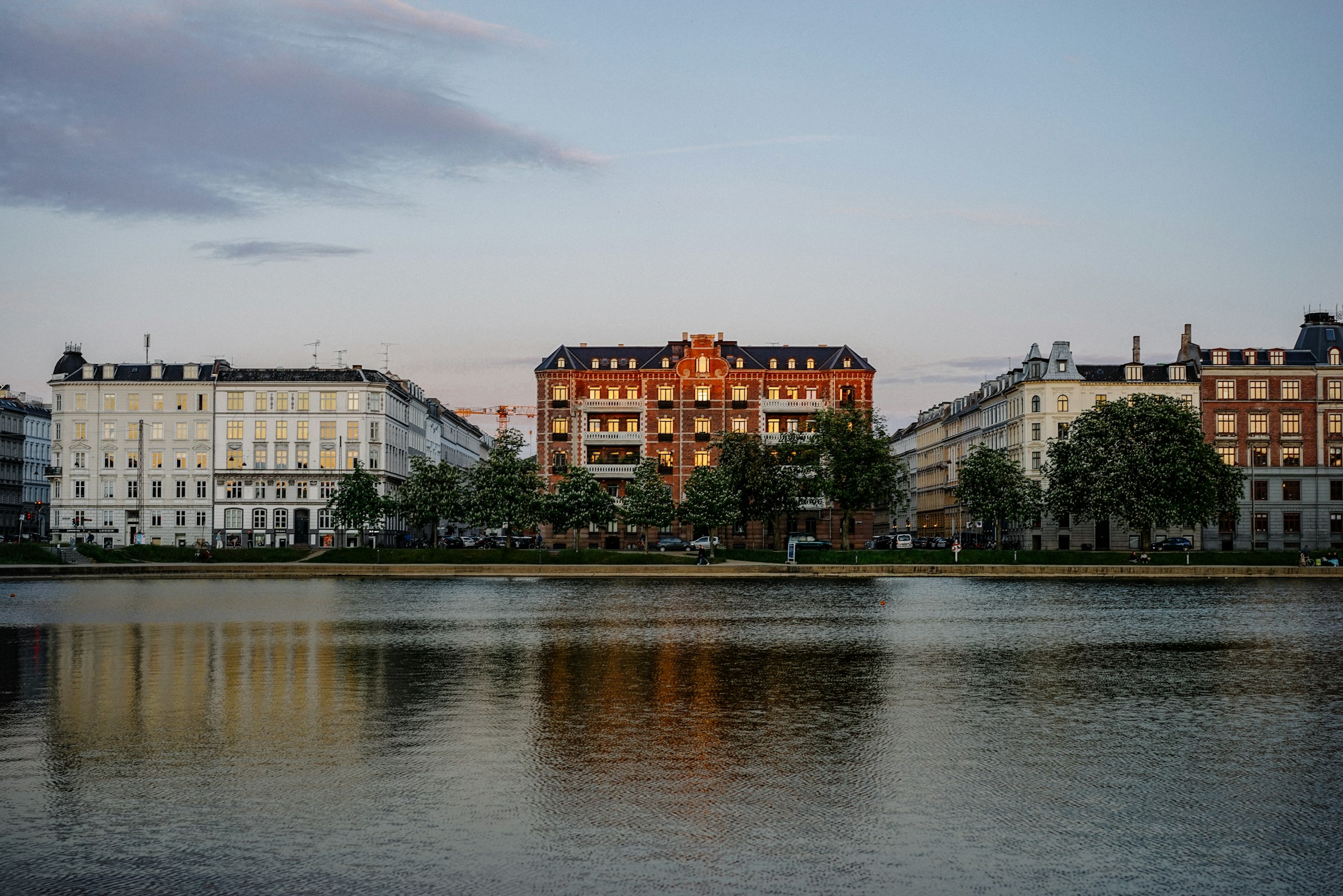 The Lakes in the evening, with the apartment blocks of their far shore. The course runs beside them at about 7.0 km and crosses them on Dronning Louises Bro at 14.3 km. Photograph: wen chen, Unsplash.