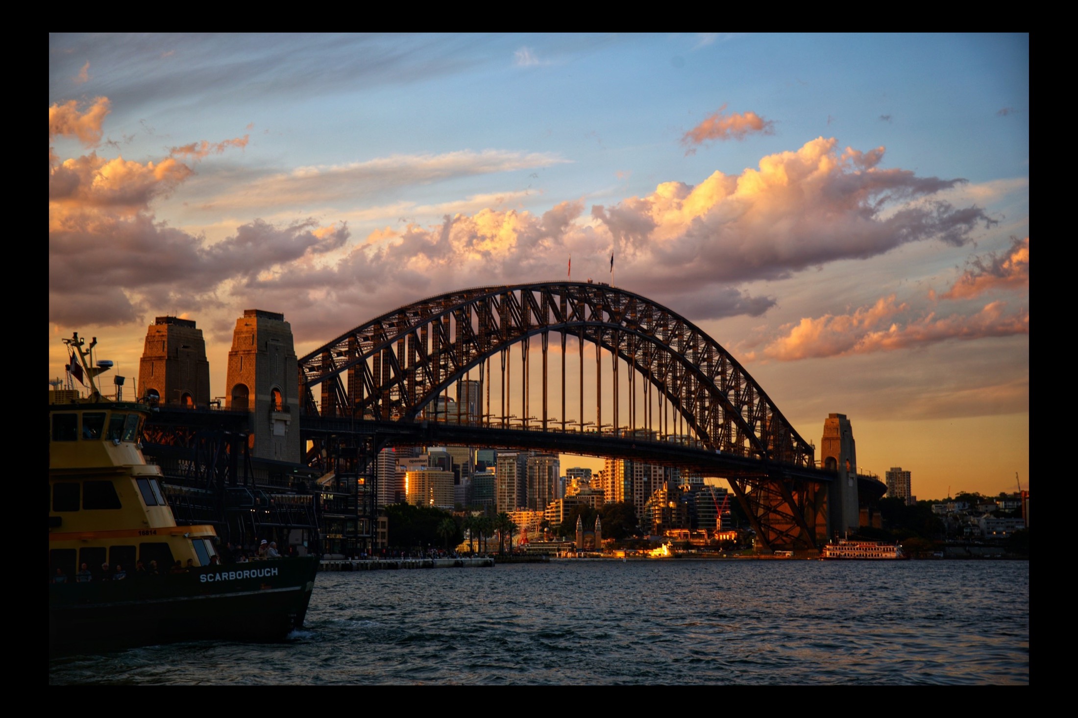 The Sydney Harbour Bridge spanning the harbour, seen from the water at Circular Quay.
